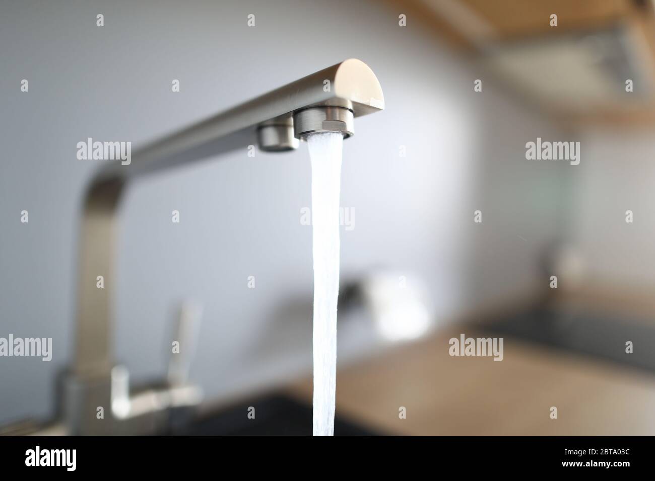 Closeup jet water from silver tap in kitchen Stock Photo Alamy