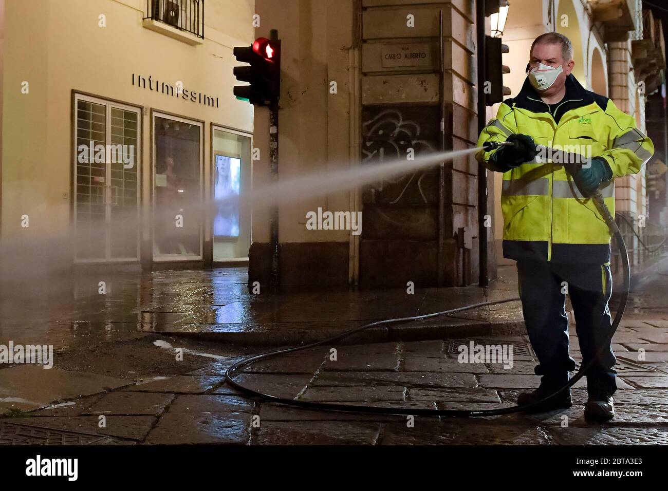 Turin, Italy - 14 March, 2020: An operator of Amiat (Multiservice Environmental Hygiene Company Turin) sanitizes street. The Italian government imposed unprecedented restrictions to halt the spread of COVID-19 coronavirus outbreak. Credit: Nicolò Campo/Alamy Live News Stock Photo