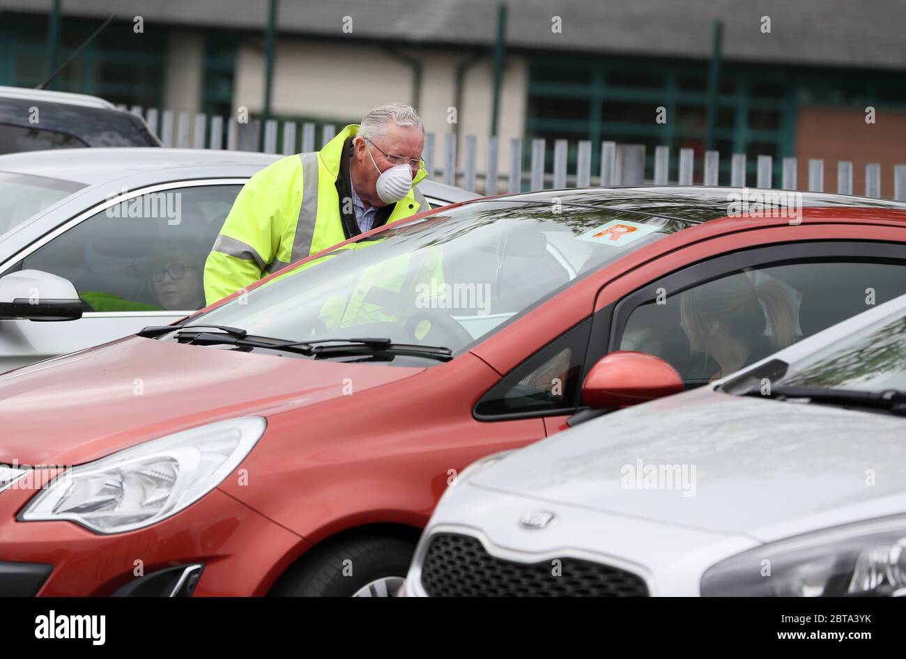 Raymond Hyde, a deacon at Maghaberry Elim Pentecostal Church, Craigavon, speaks with people who have parked for a drive in service as a number of churches are restarting drive-in services following the easing of restrictions in Northern Ireland due to coronavirus pandemic. Stock Photo