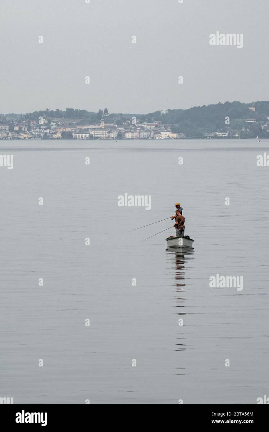 Two professional fishing rods on lake Bled, Slovenia. Fishermen waiting for  fish on the coast of lake Bled on a sunny day Stock Photo - Alamy