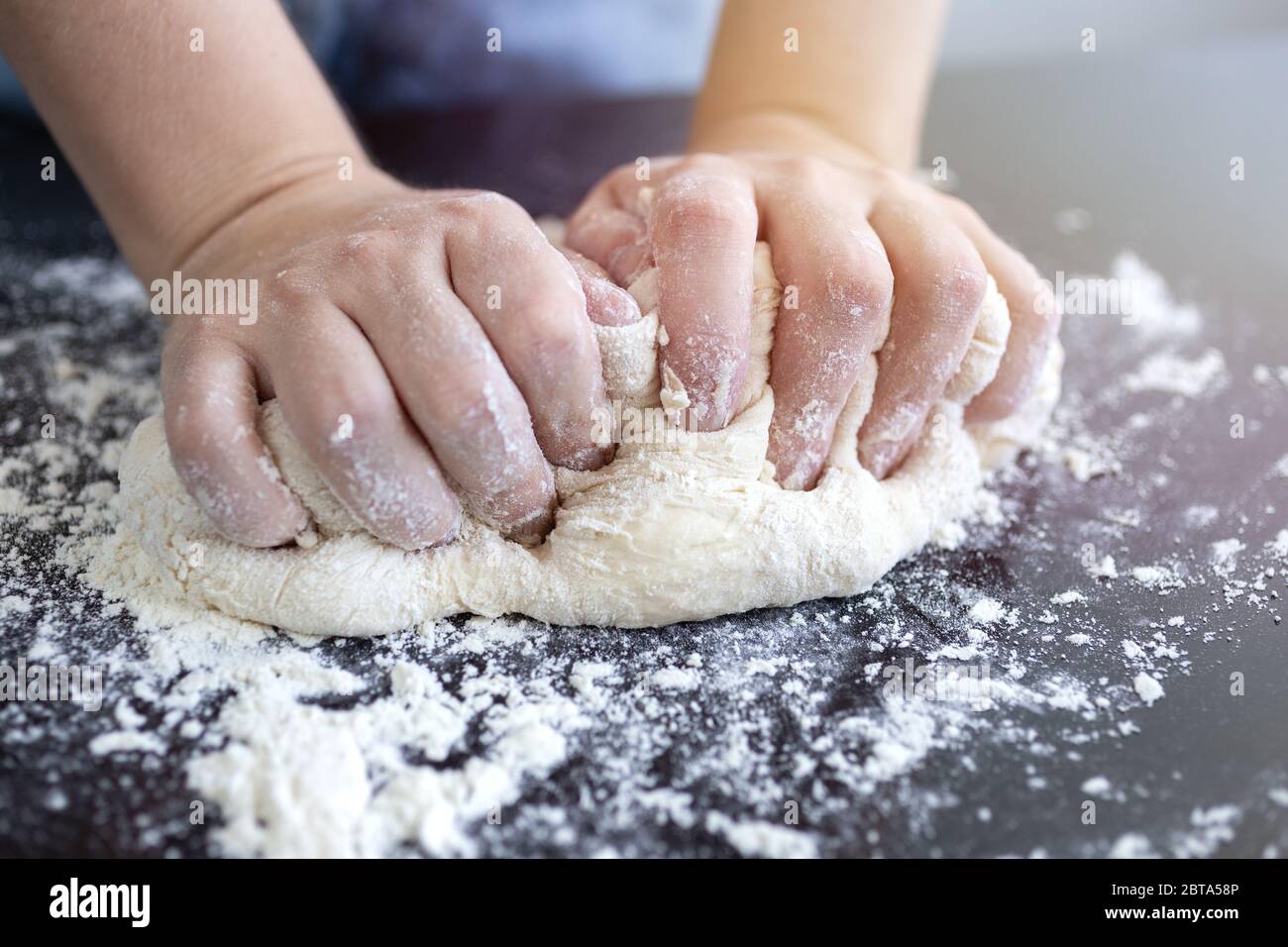 Close up of hands kneading dough for bread, pasta or pizza Stock Photo
