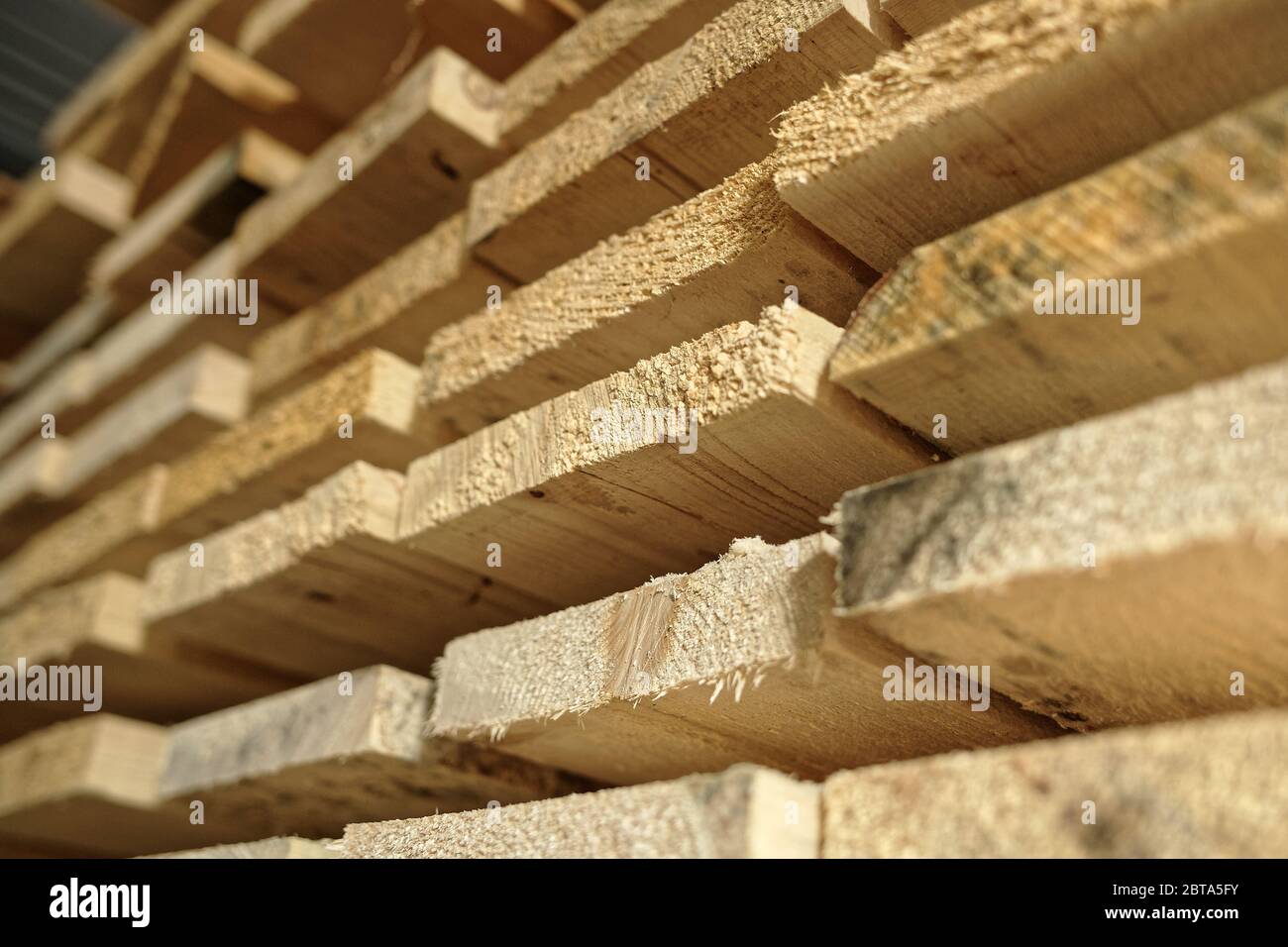 Construction lumber. Dry boards are stacked. A close-up of wood in the end. the woodworking industry and sawmills Stock Photo