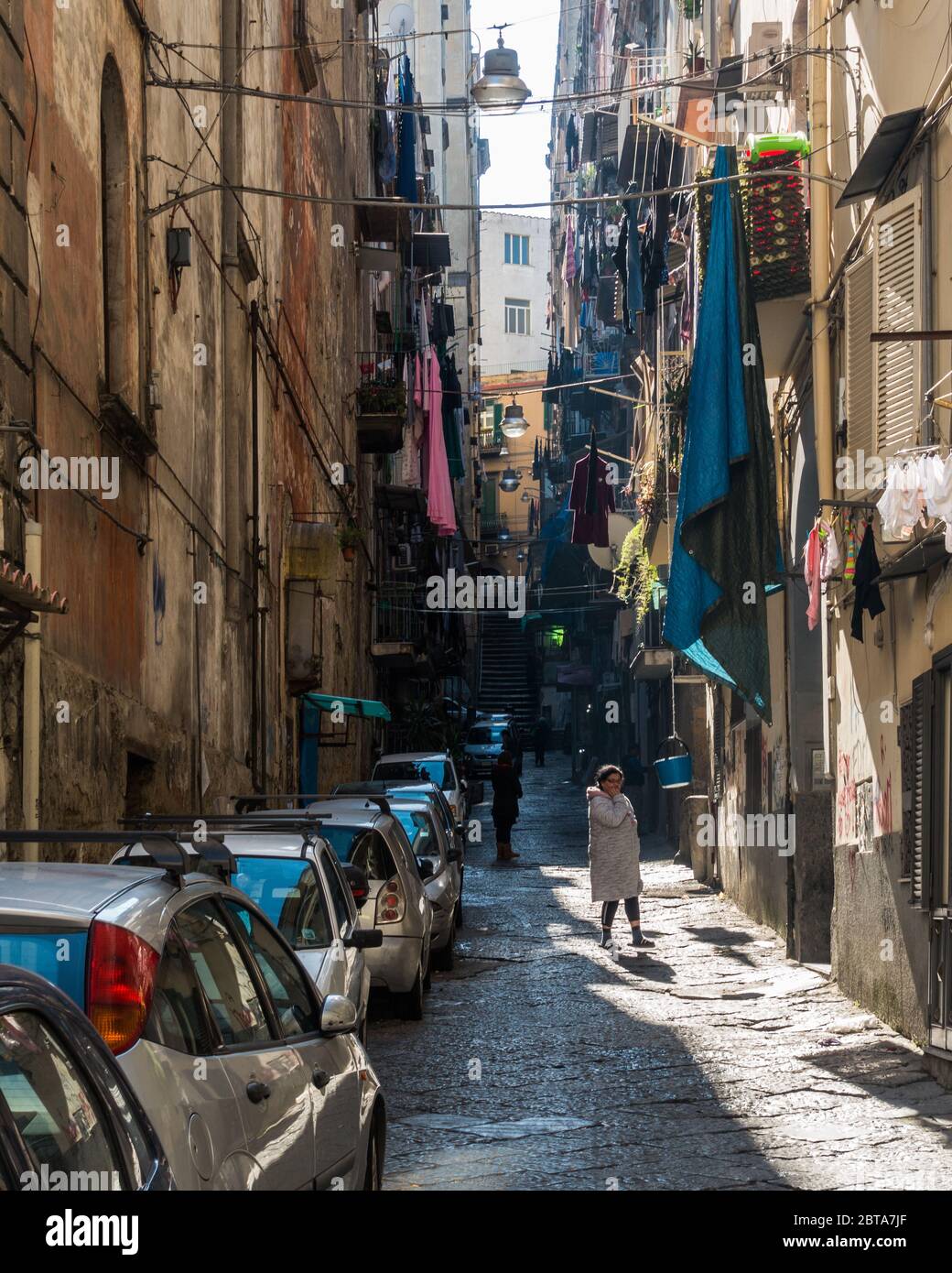 Naples, Italy, February 8, 2020 – A typical pedestrian street of Rione Sanità with clothes hanging from the balconies to dry Stock Photo