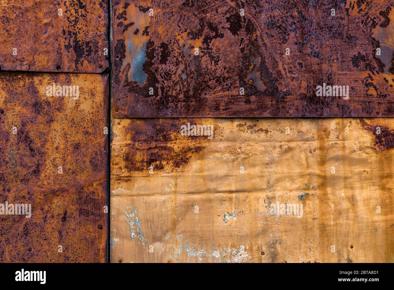 Rusted flat composite nailed metal sheets surface background and texture. Stock Photo