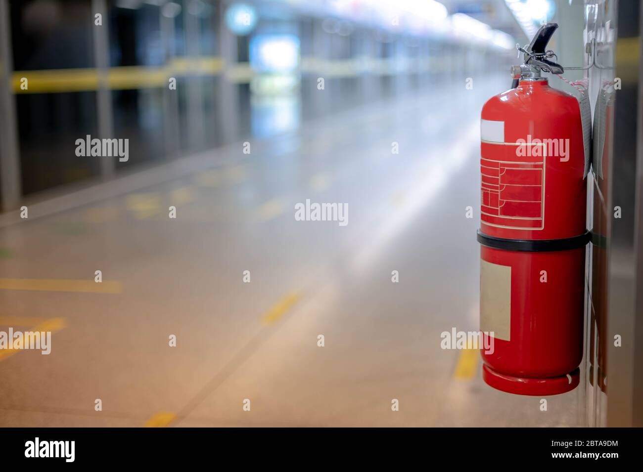 Fire extinguishers hanging on the wall available in fire emergencies at