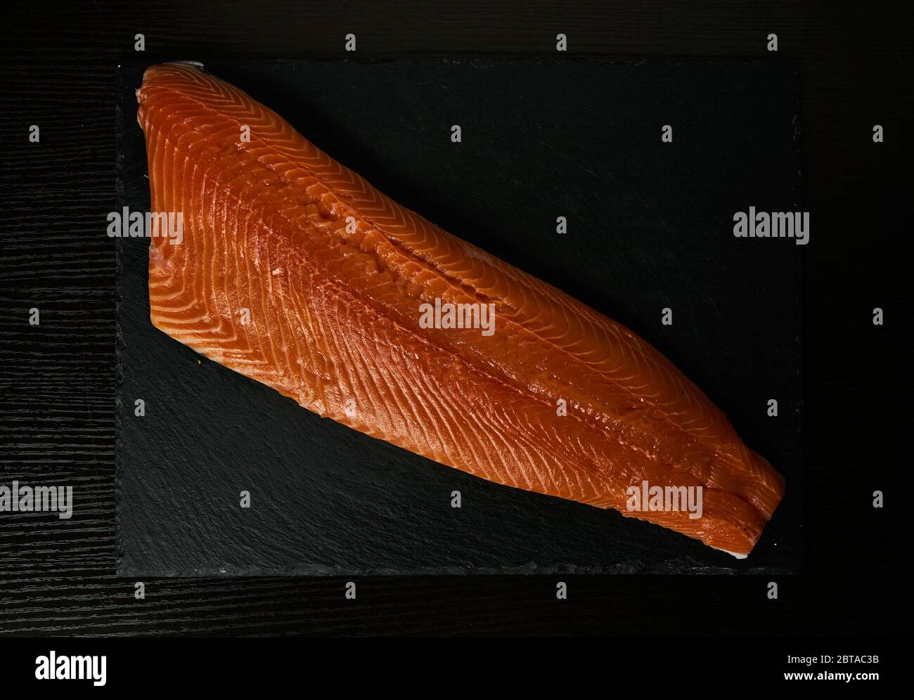fresh raw salmon fillet at black background Stock Photo - Alamy