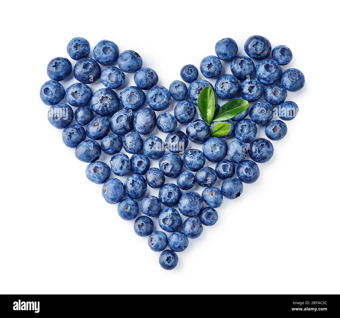 Heart made of blueberries and blueberry leaves isolated on a white background Stock Photo