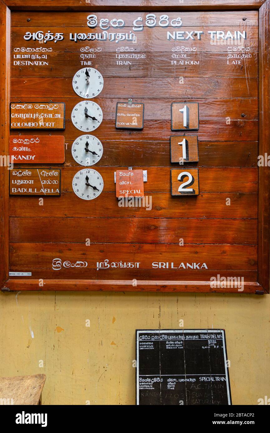 Train to Ella from Nanu Oya station.  Wooden, manually operated departure board at the station. Stock Photo