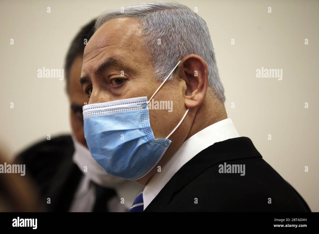 Jerusalem, Israel. 24th May, 2020. Israeli Prime Minister Benjamin Netanyahu, wearing a face mask, looks on while standing inside the court room as his corruption trial opens at the Jerusalem District Court on Sunday, May 24, 2020. Netanyahu attacked the Israeli justice system as he became the first sitting prime minister to go on trial. Pool Photo by Ronen Zvulun/UPI Credit: UPI/Alamy Live News Stock Photo