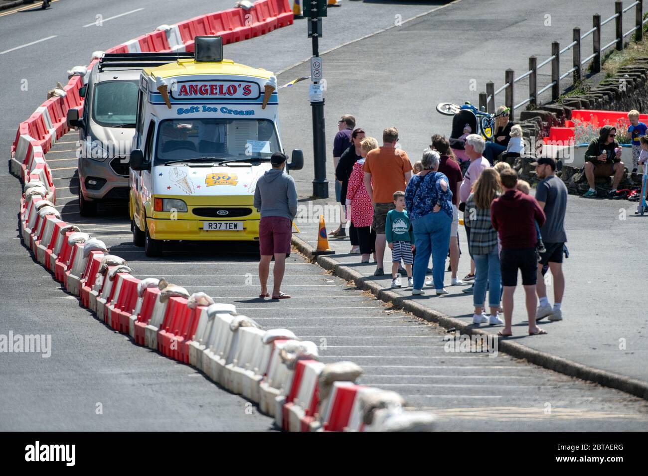People queue for an ice cream on the sea front at Clevedon in Somerset after coronavirus lockdown restrictions were eased in England last week. Stock Photo