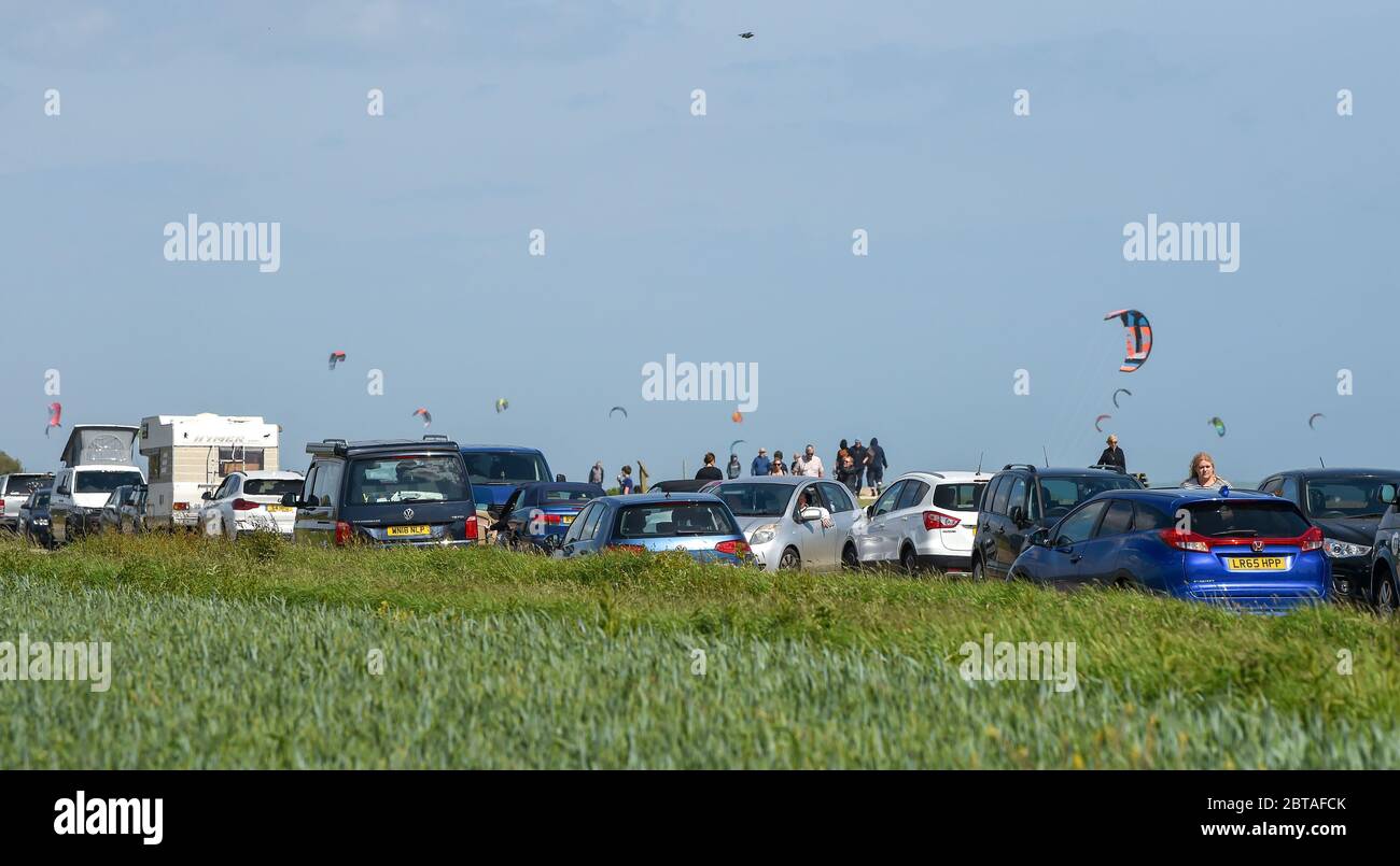 Worthing UK 24th May 2020 - Traffic congestion on the seafront as visitors and kite surfers enjoy the windy but sunny weather at Goring Gap near Worthing in West Sussex this bank holiday weekend during the coronavirus COVID-19 pandemic . : Credit Simon Dack / Alamy Live News Stock Photo