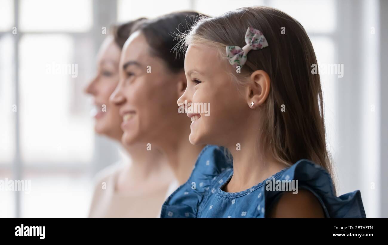 Profile view of three generations of women look in distance Stock Photo