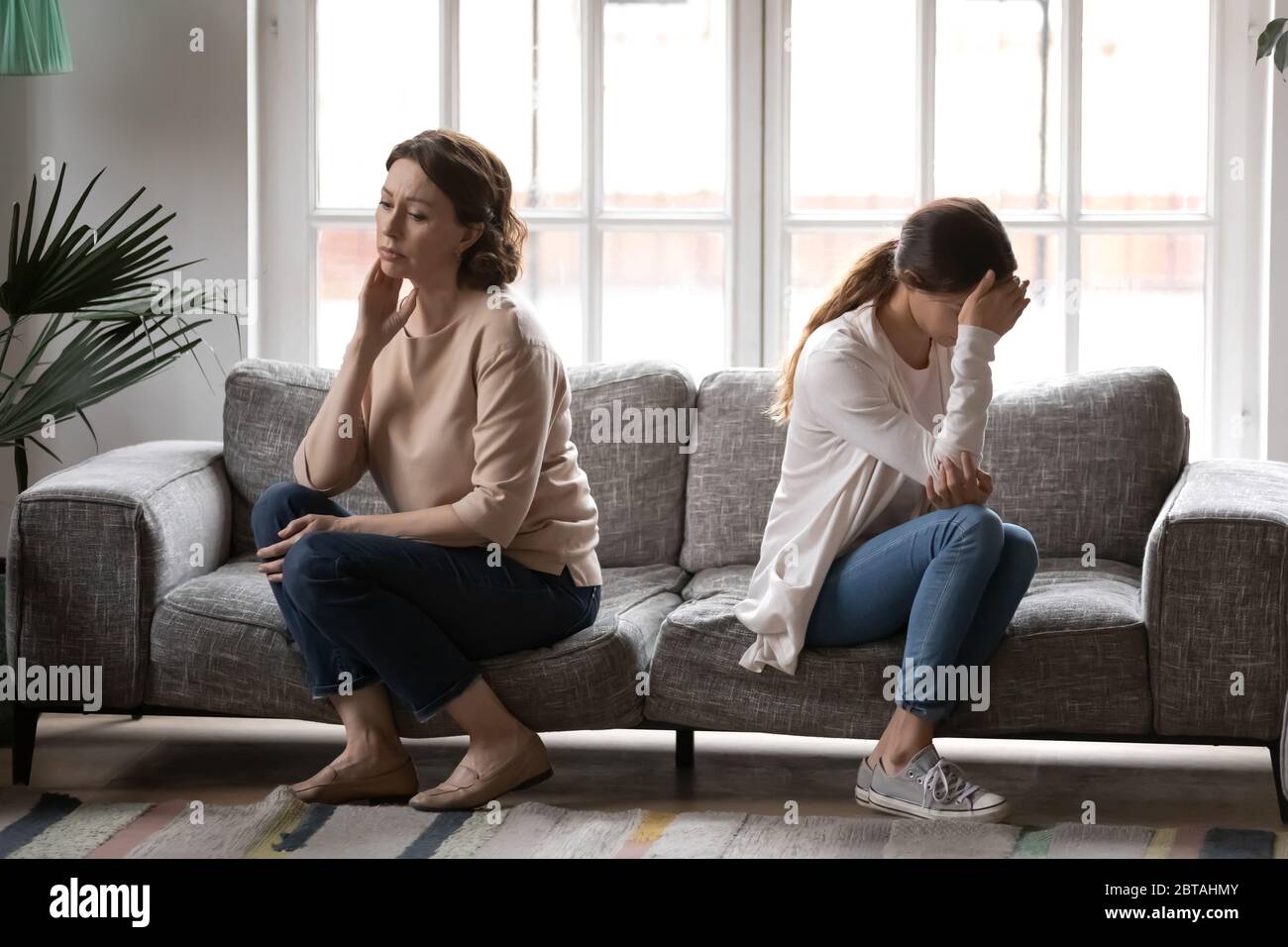 Offended mature mom and adult daughter avoid talking Stock Photo