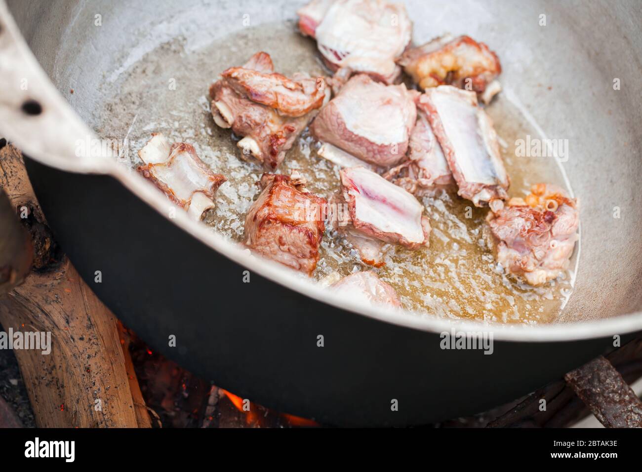 Pieces of lamb meat on bones stew in a cauldron. Preparing of Chorba