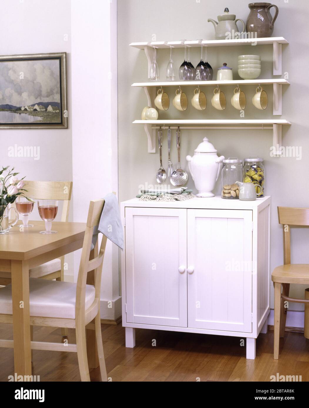 White shelving and cupboard in dining room Stock Photo Alamy