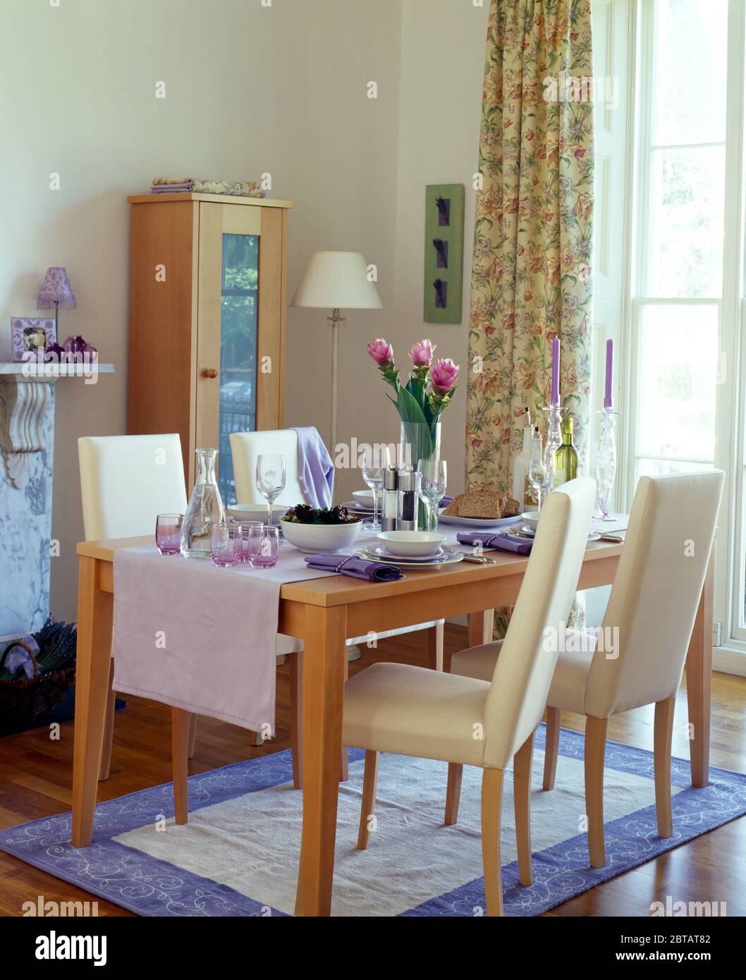 Tall Back Cream Chairs At Simple Wood Table In Modern Dining Room Stock Photo Alamy