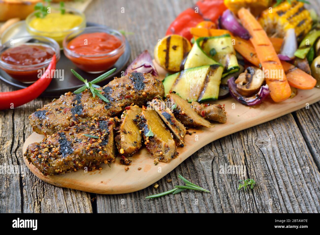 Grilled vegan steaks with mixed vegetables and spicy barbecue sauces Stock Photo Alamy