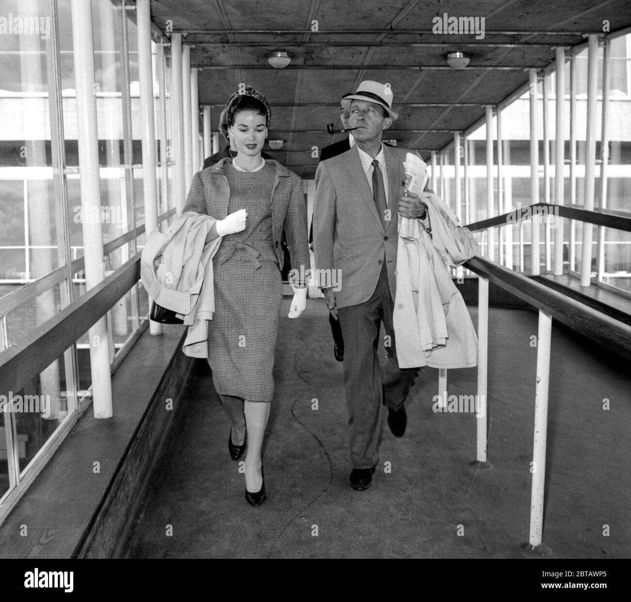 Heading for the Olympics in Rome, Hollywood movie actor & singer Bing Crosby and his wife Kathryn take a flight from London Airport Stock Photo