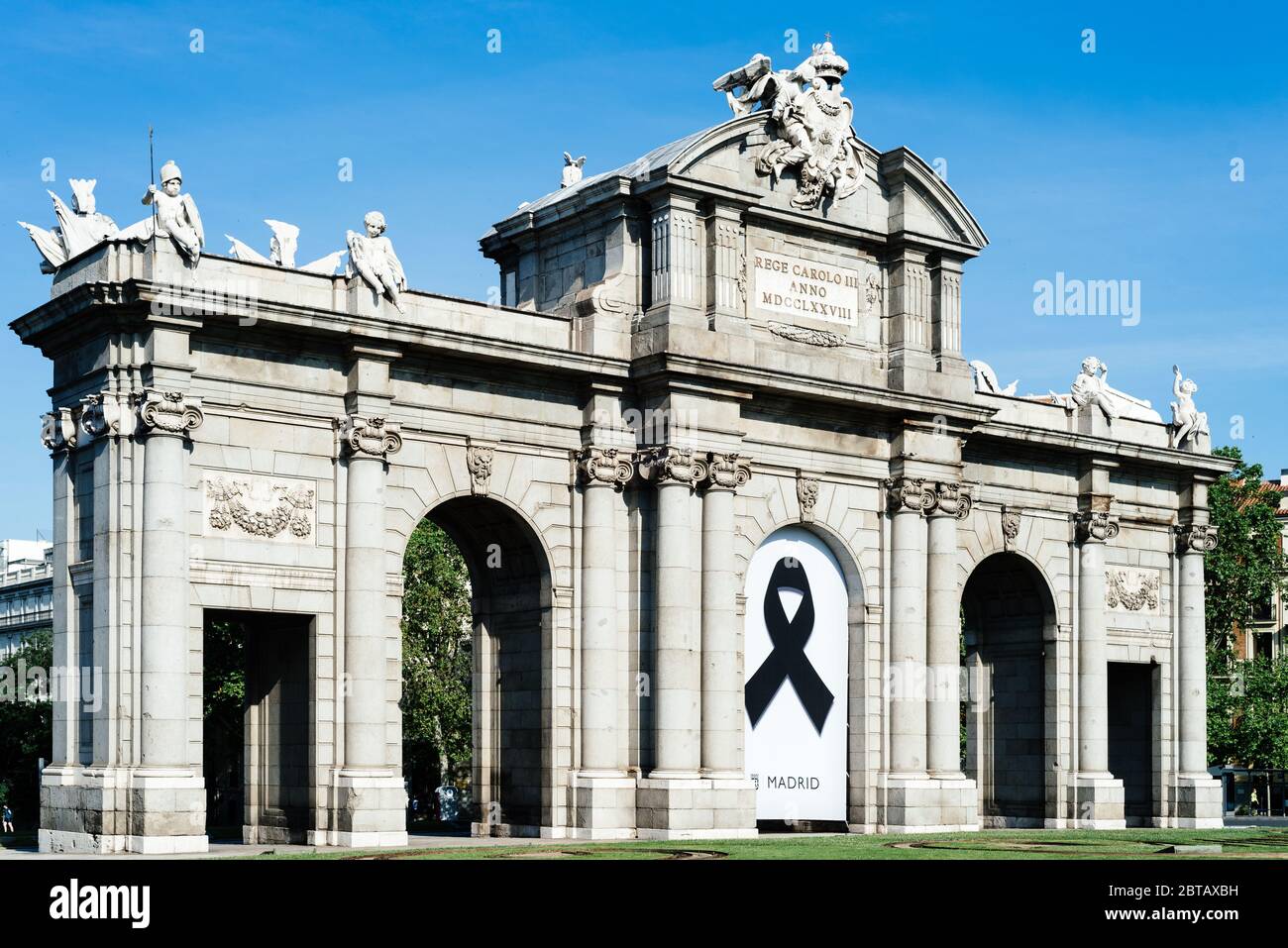 Madrid, Spain - May, 23, 2020: Puerta de Alcala, or Alcala Gate. Banner with black ribbon as a symbol of mourning for those who have died during the c Stock Photo
