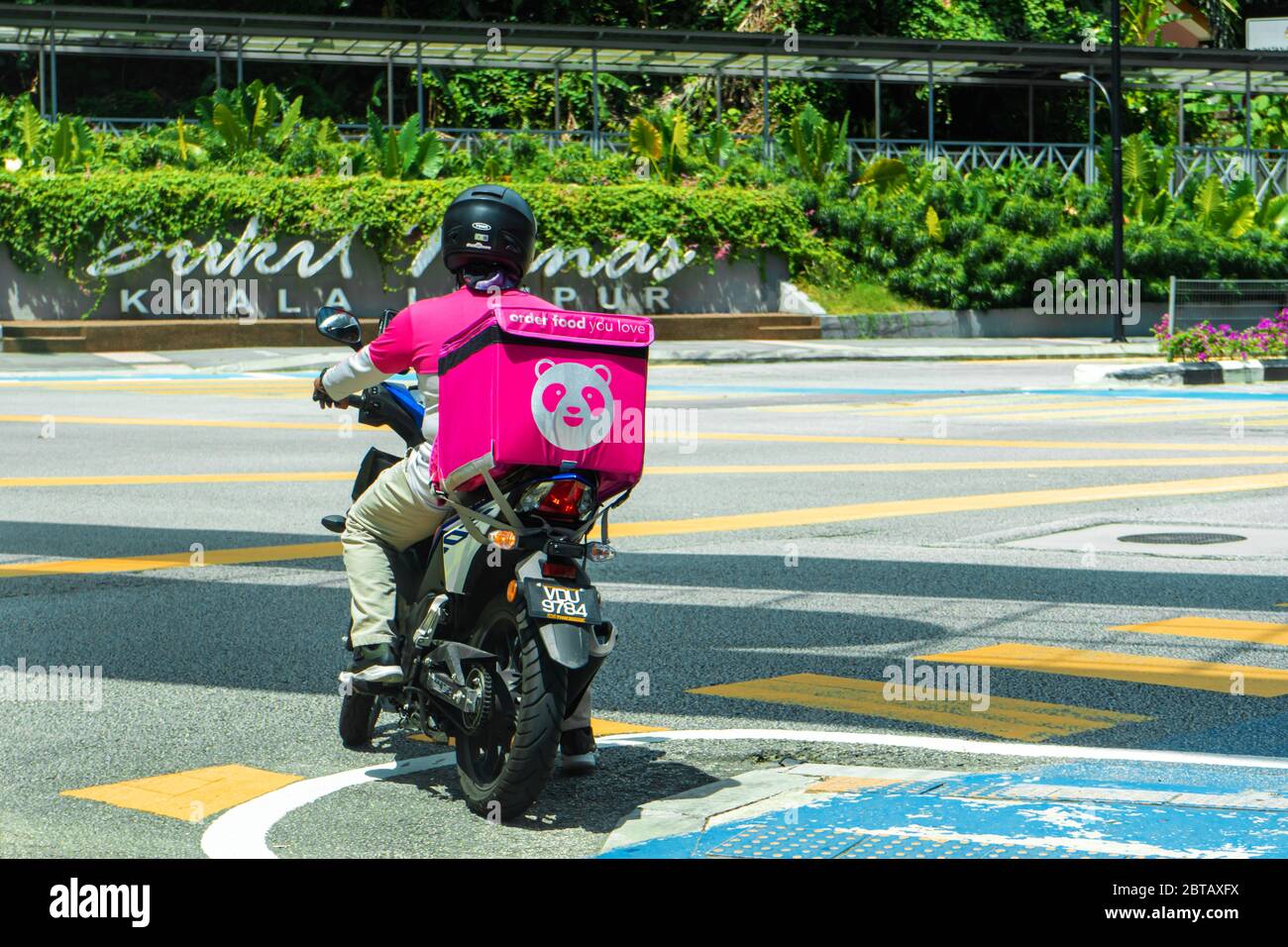 Courier Of A Popular Food Delivery Service In Malaysia On A Bike Food Ordering Home Stock Photo Alamy