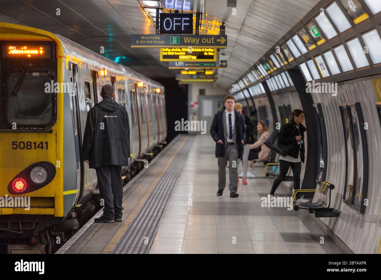 Liverpool Moorfields underground station,  Merseyrail class 508 508141 the  Conductor / guard waiting for departure time Stock Photo