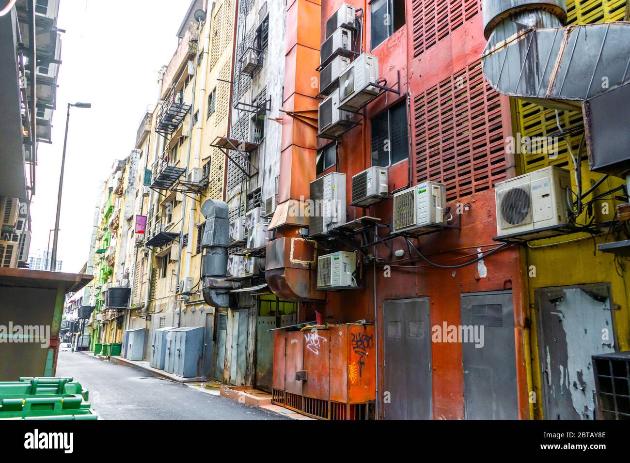 Homes in Asia hung with air conditioning. Hot climate. Narrow streets. The spirit of Asia Stock Photo