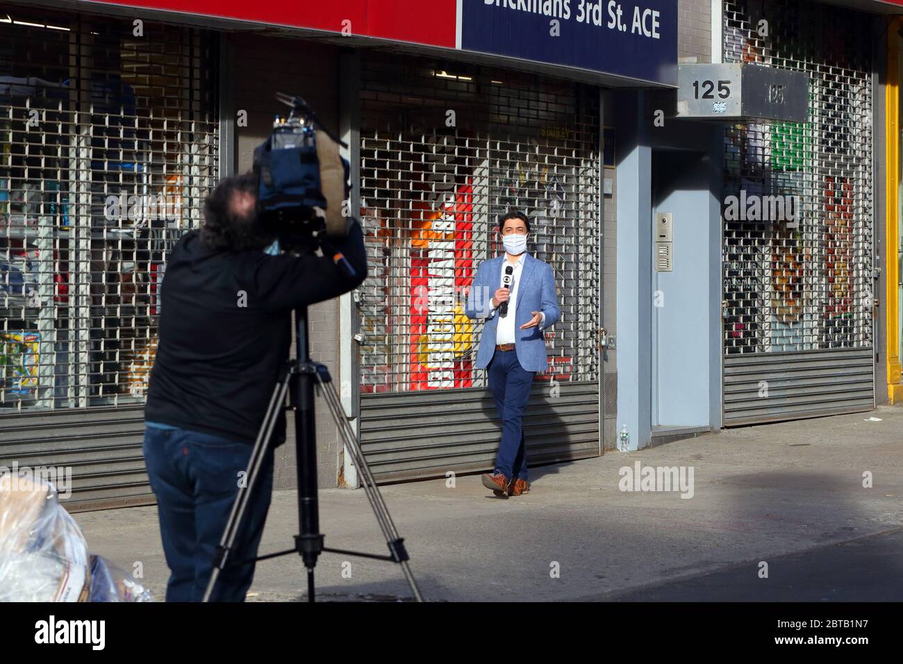 A mask wearing Brazilian TV Globo news reporter Tiago Eltz about to record  a coronavirus COVID-19 related news story in New York Stock Photo - Alamy