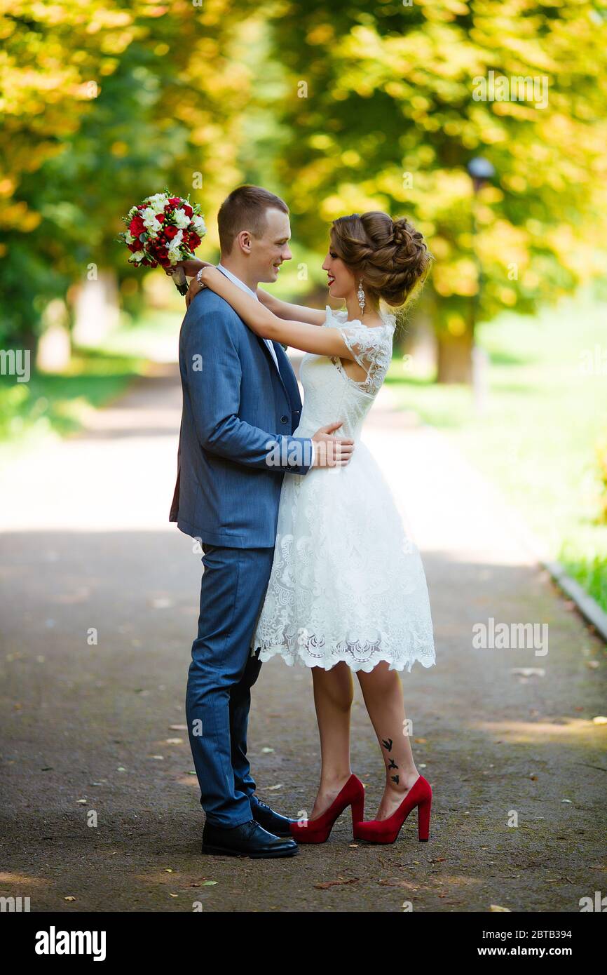 Wedding couple, happy newlyweds and husband hugging in green park Stock ...