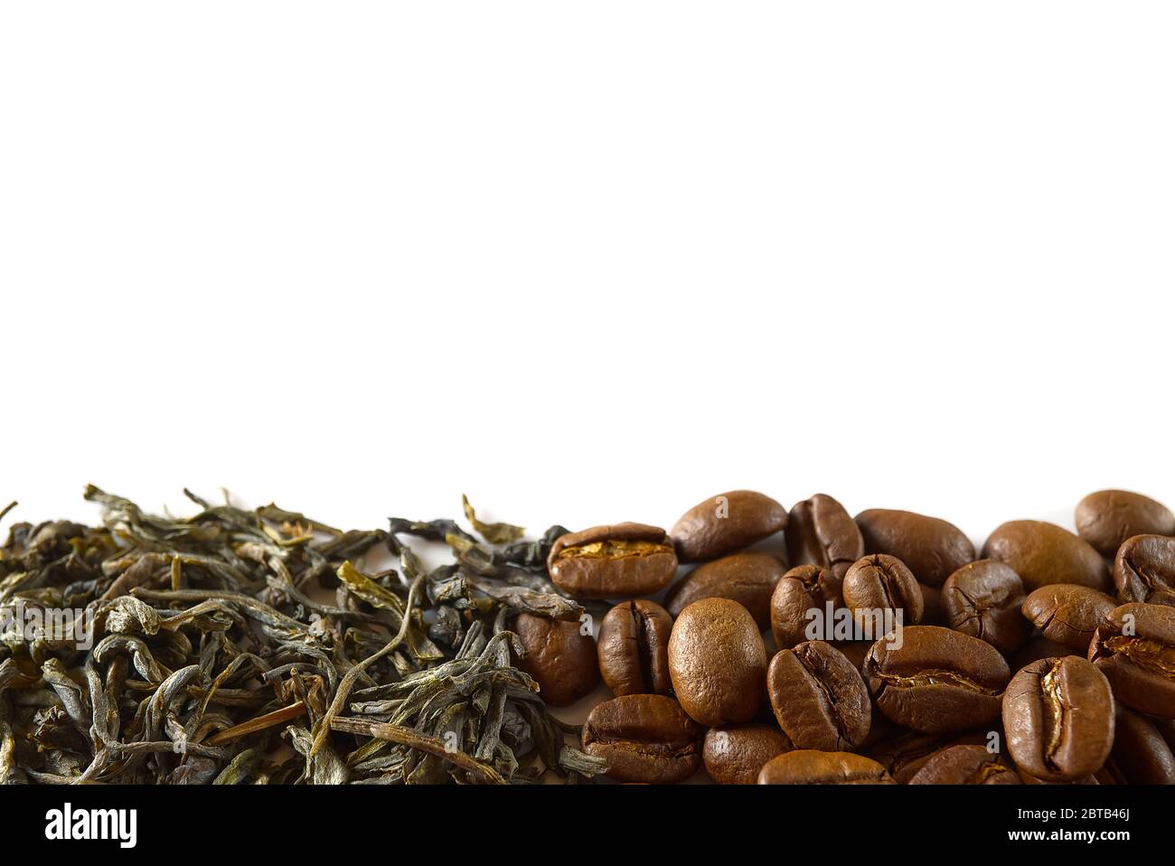Pile of coffee beans and dry green tea leaves isolated on white ...