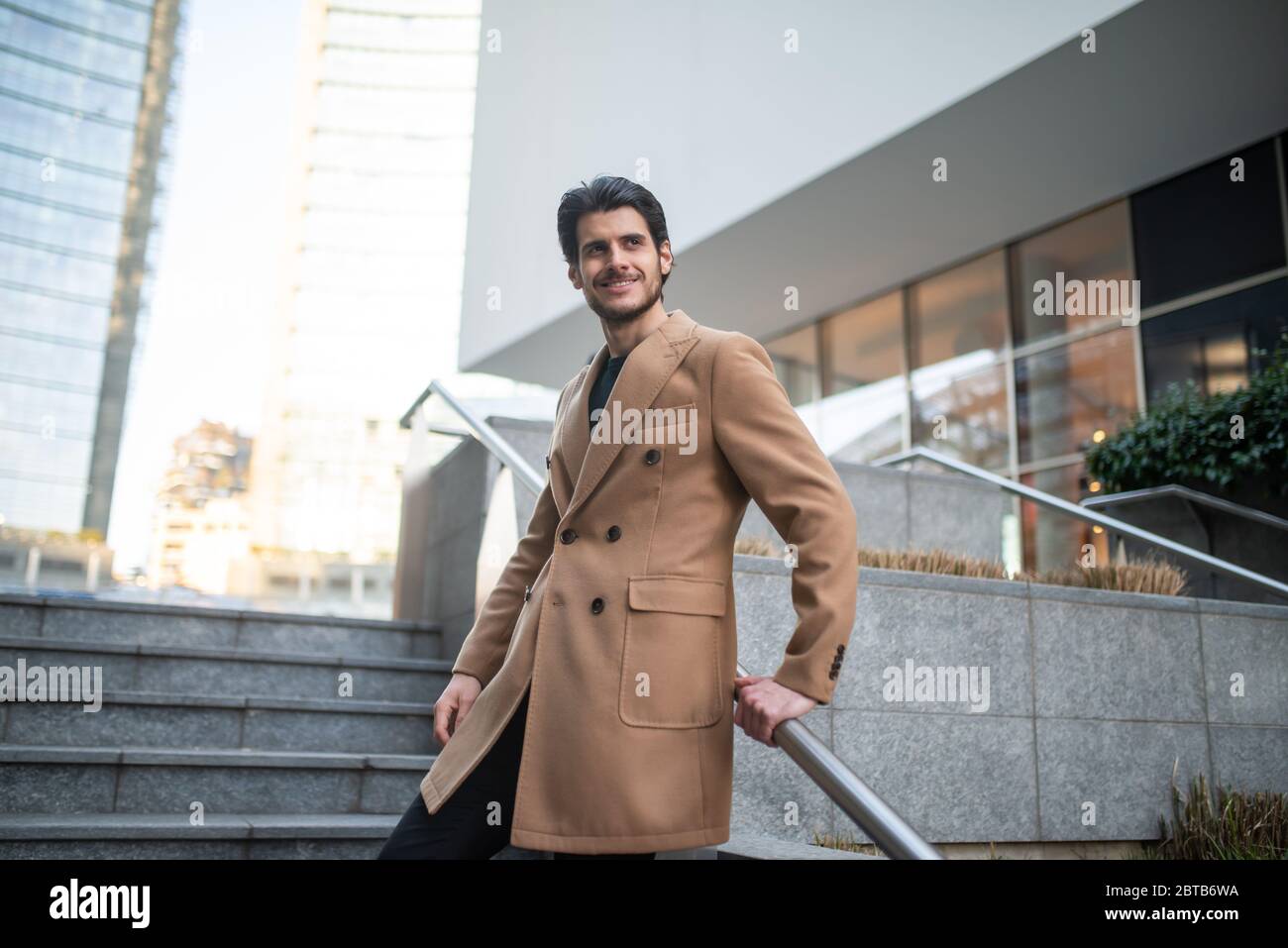 Outdoor fashion portrait of a young smiling man Stock Photo - Alamy