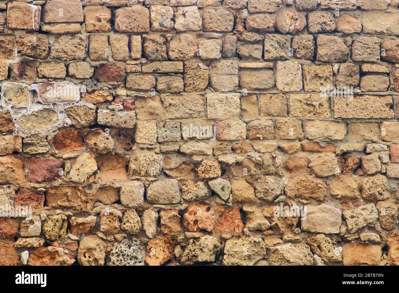 Ancient brickwork destroyed by time closeup as background Stock Photo