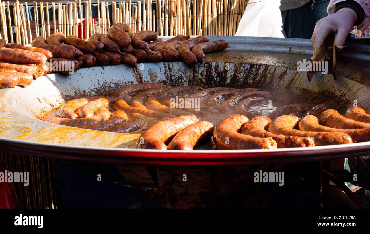 Sausages on Commercial Griddle Hotplate. Stock Photo