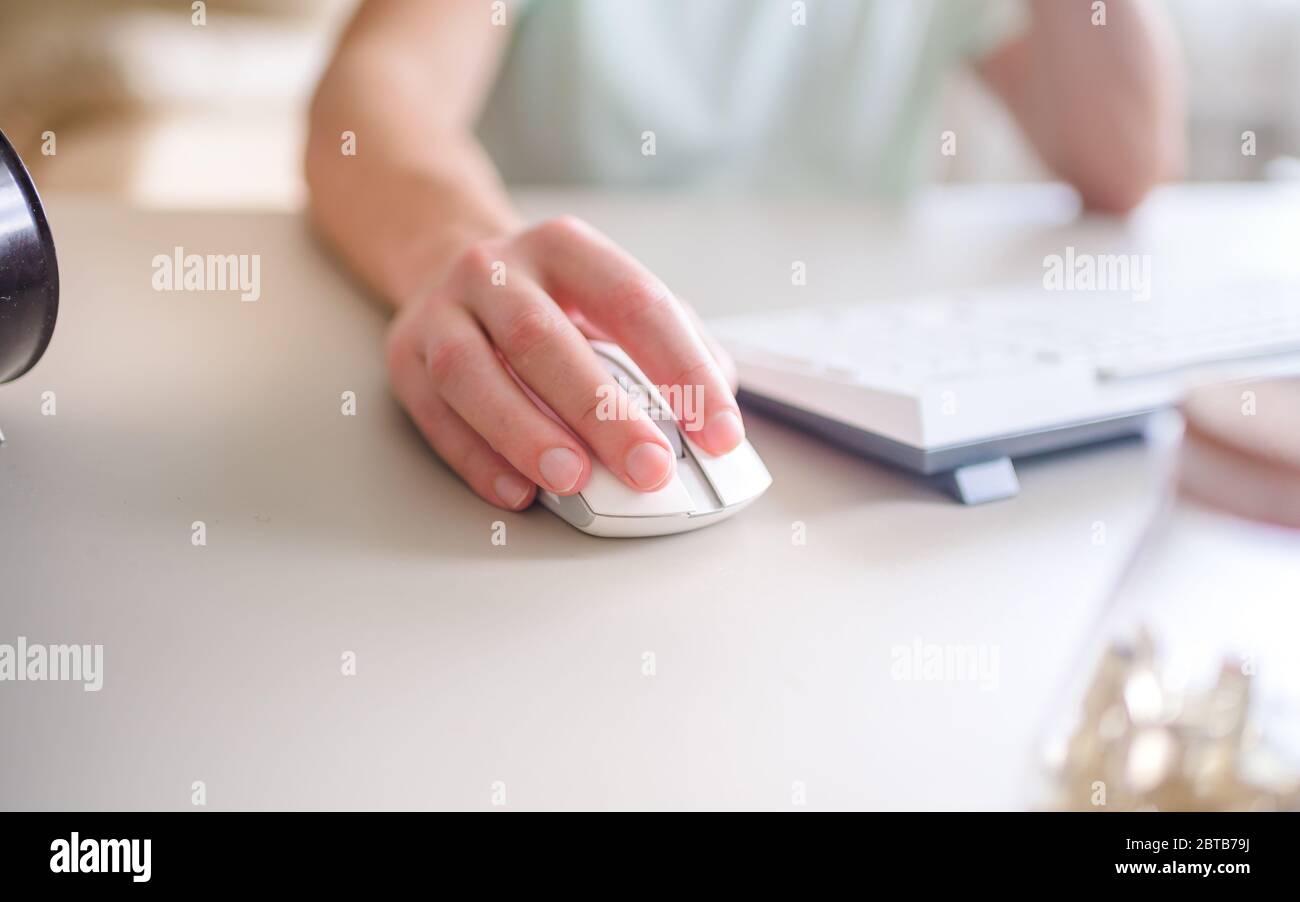 the developer works at computer, uses the mouse Stock Photo