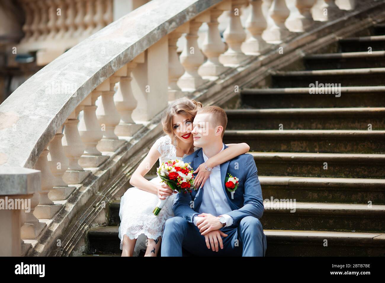 Fabulous young wedding couple posing in the park on the sunny day. Stock Photo
