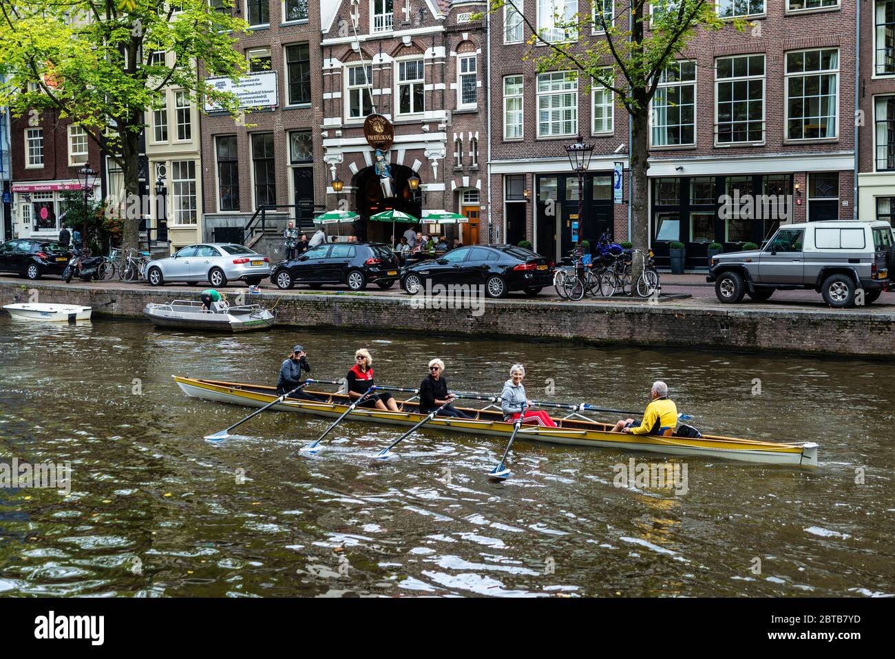 Amsterdam, Netherlands - September 8, 2018: Senior women rowing a recreational boat along of a canal in Amsterdam, Netherlands Stock Photo