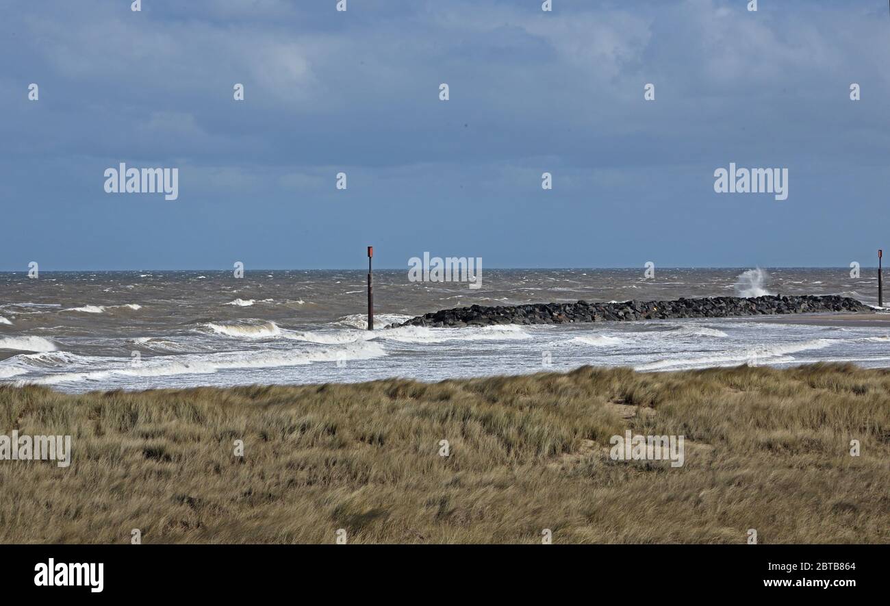 view over marram grass to rough sea and off-shore reef  Eccles-on-Sea, Norfolk, UK, Europe                        April Stock Photo