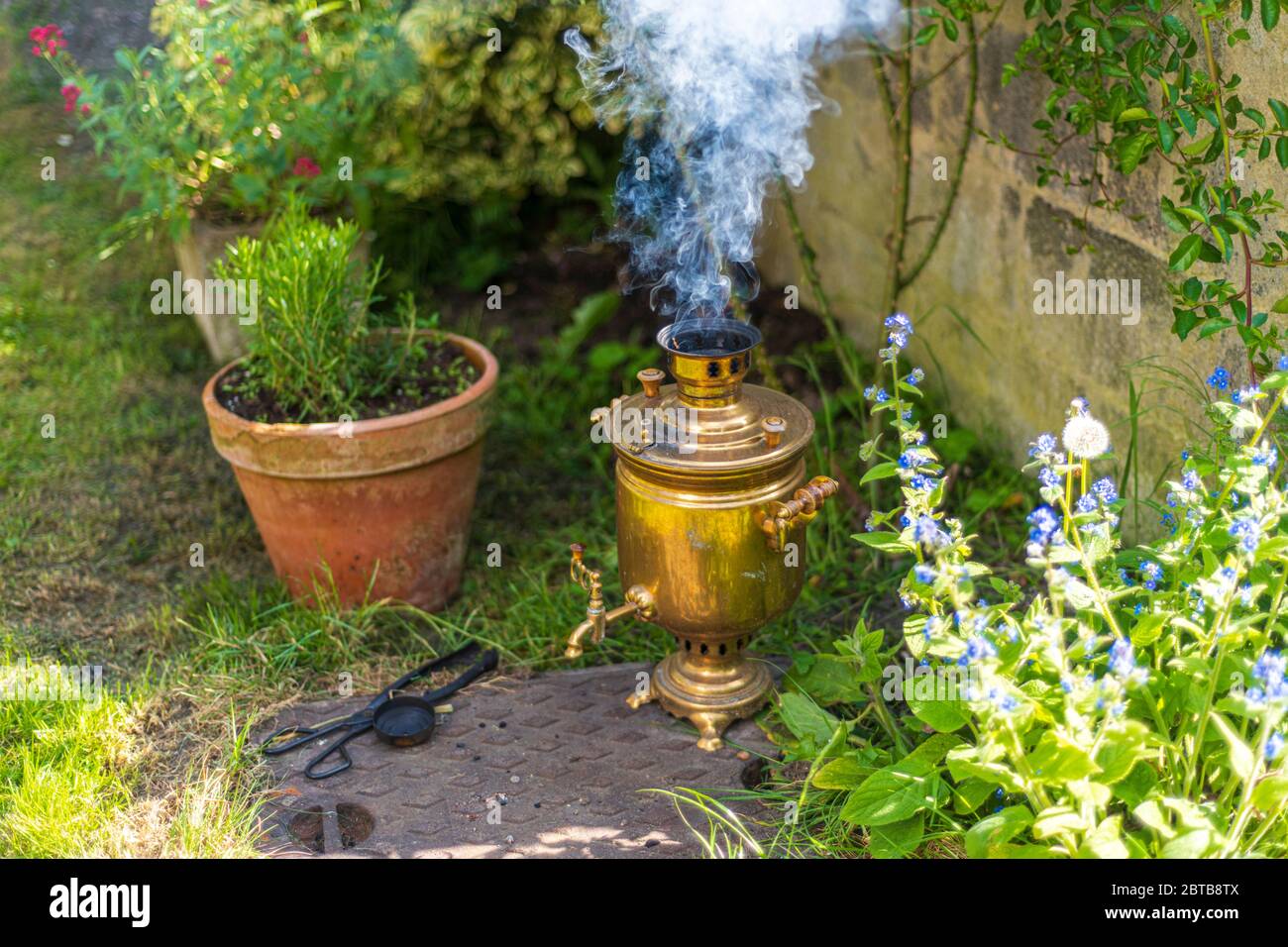 Old vintage samovar with smoke. Brewing tea in the old fashioned way. Russian ceremony Stock Photo