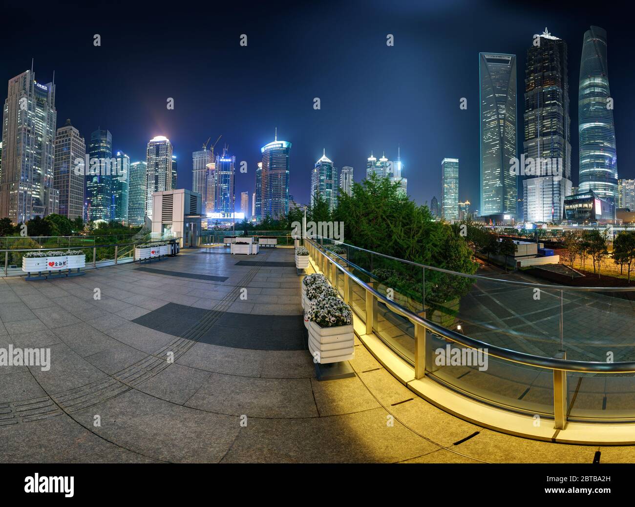 SHANGHAI, CHINA - APRIL 21, 2015: 360 degrees skyline of Pudong financial center by night. Pedestrian, aerial walkway at Lujiazui.Left part,can be com Stock Photo