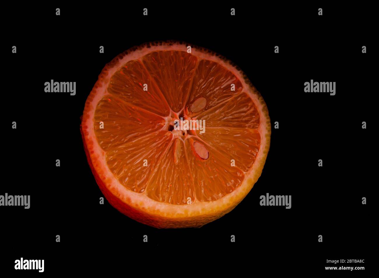 Sliced orange isolated on black background. Fruit chips. Stock Photo