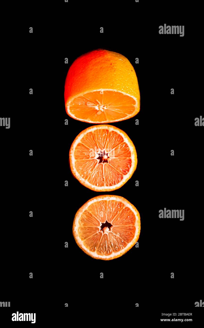 Sliced orange isolated on black background. Fruit chips. Stock Photo