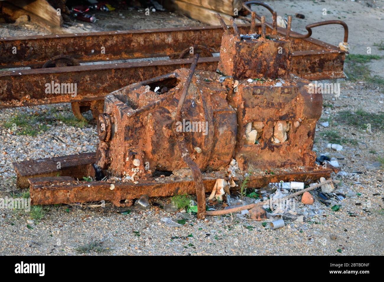 Rusty Piece of Old Machinery Lies Among Rubbish Outside the Abandoned Fish Factory on Olkhon Island, Lake Baikal, Russia Stock Photo