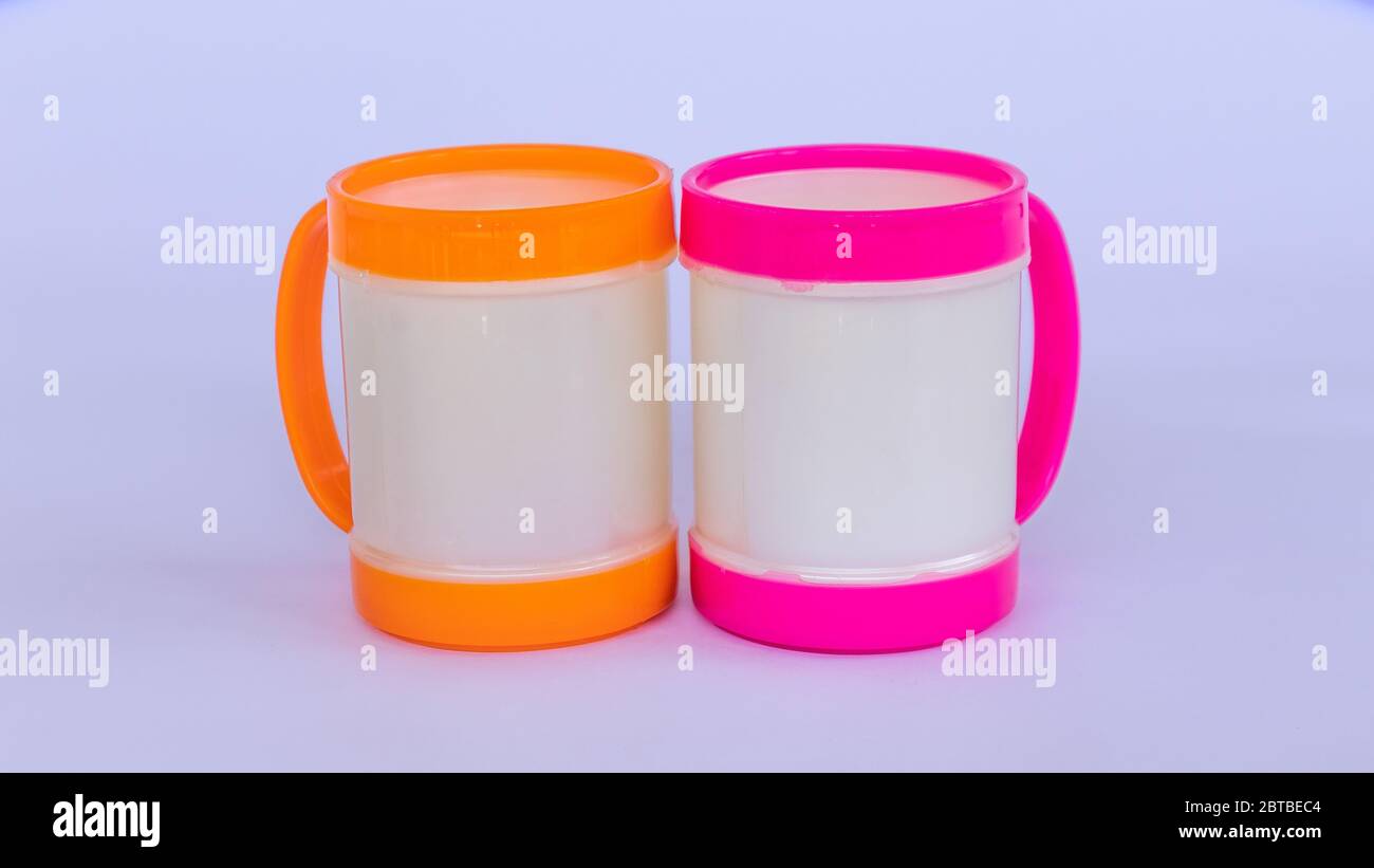 Two colorful plastic coffee mugs on a white background Stock Photo