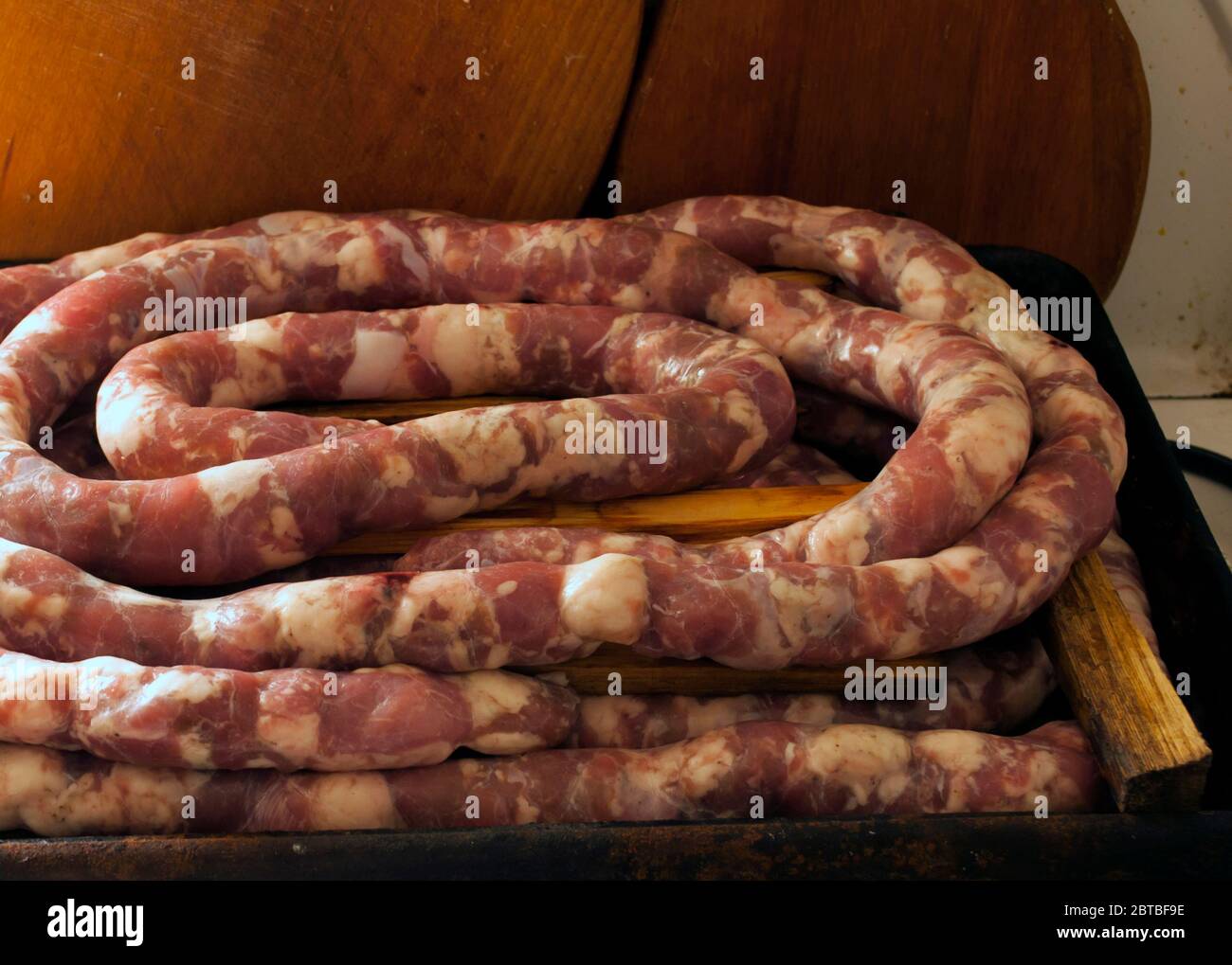 Making homemade sausage at home. Stuffing pork intestine with meat and