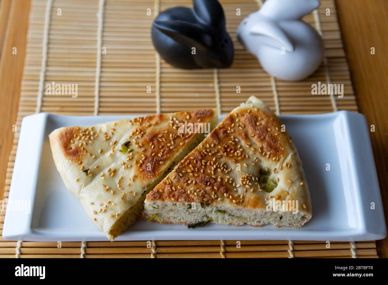 Chinese halal food known as sesame scallion bread, a popular staple in Northern China. The bread is stuffed with spring onions and topped with sesame. Stock Photo