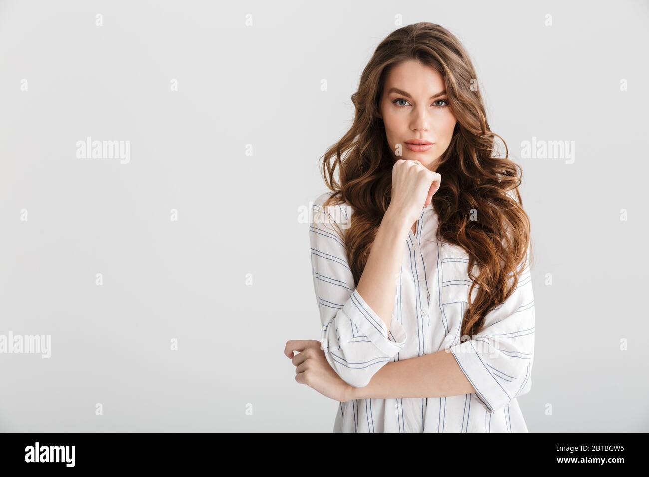 Image of thinking caucasian woman posing and looking at camera isolated ...
