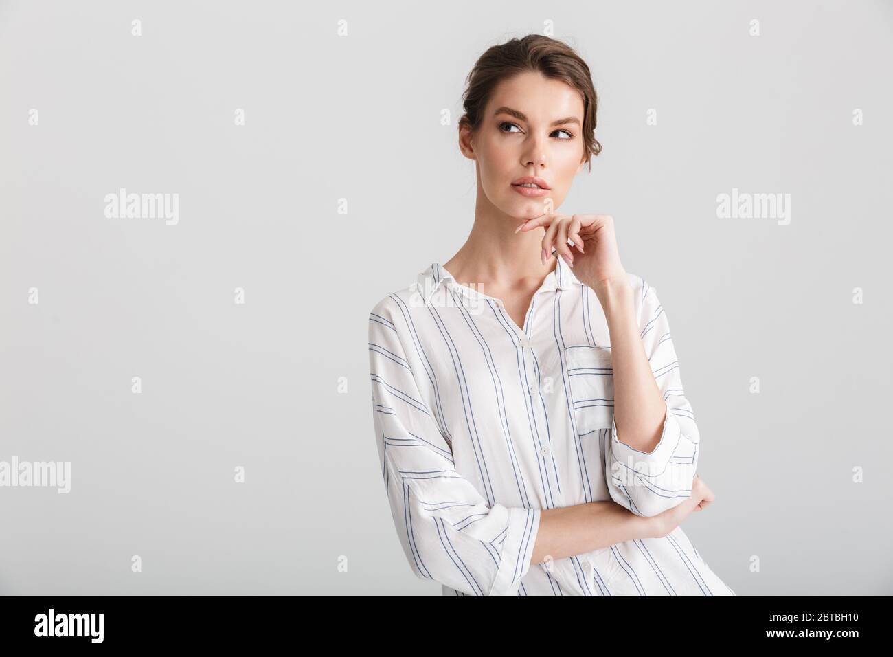 Image of serious beautiful woman thinking and looking upward isolated ...