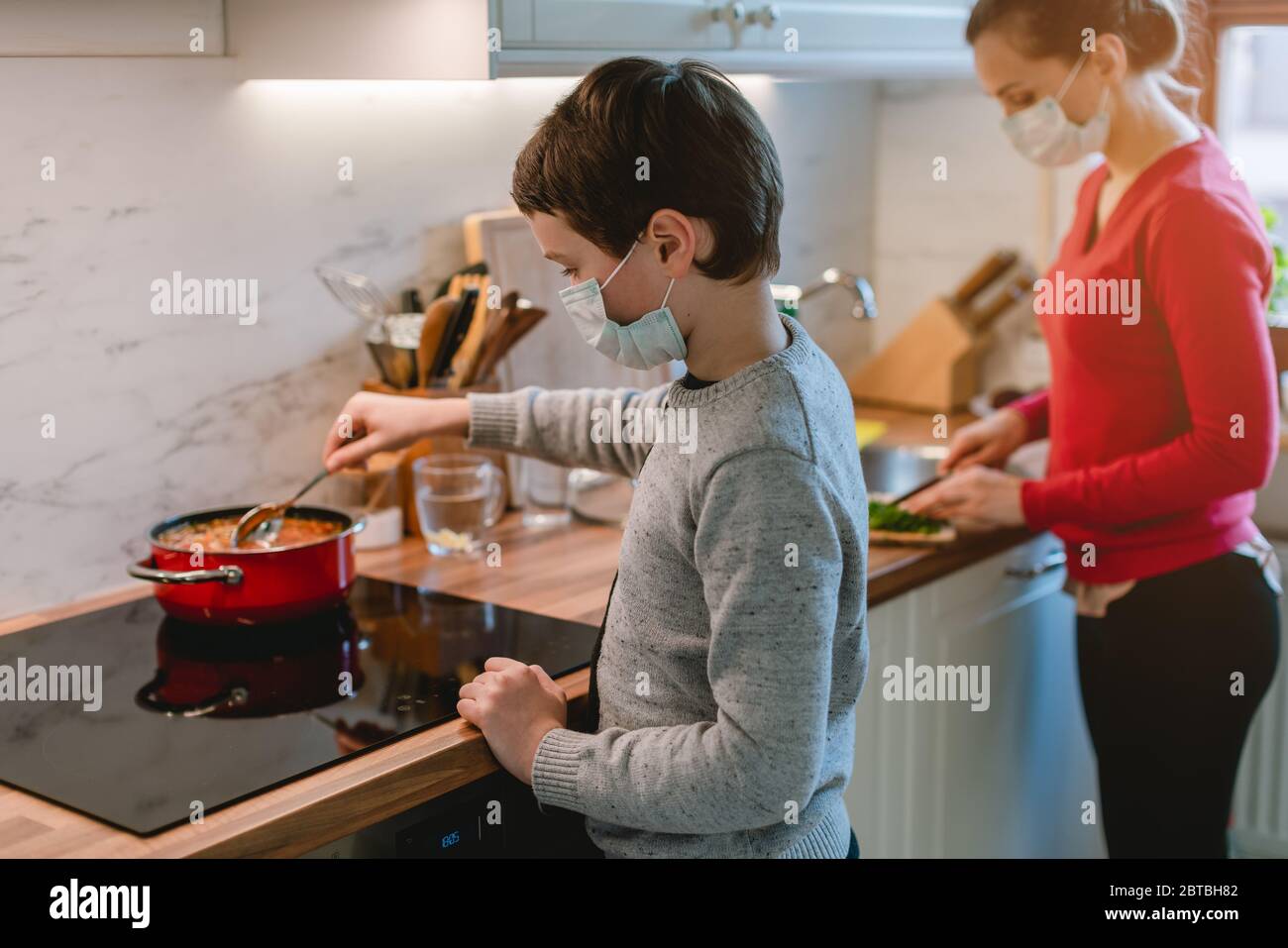 Family cooking at home during coronavirus crisis Stock Photo