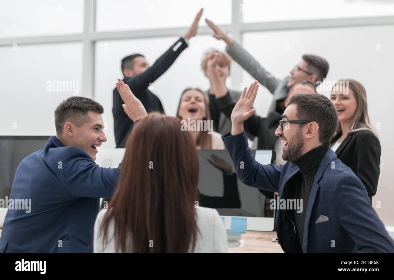 group of young business people giving each other a high five Stock ...