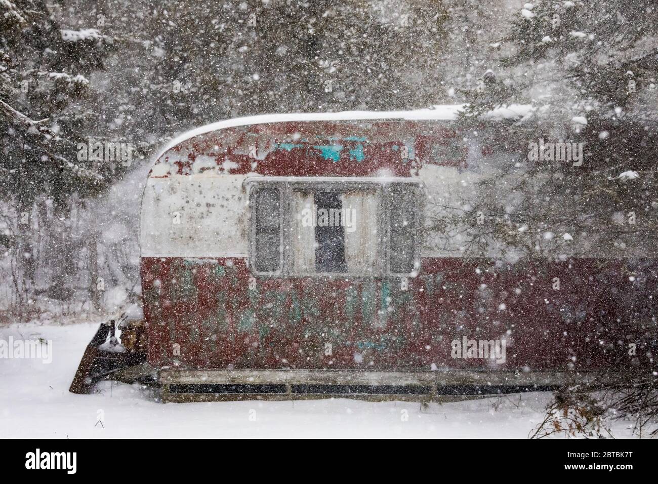 Old trailer during an April snowstorm in central Michigan, USA [No property release; available for editorial licensing only] Stock Photo