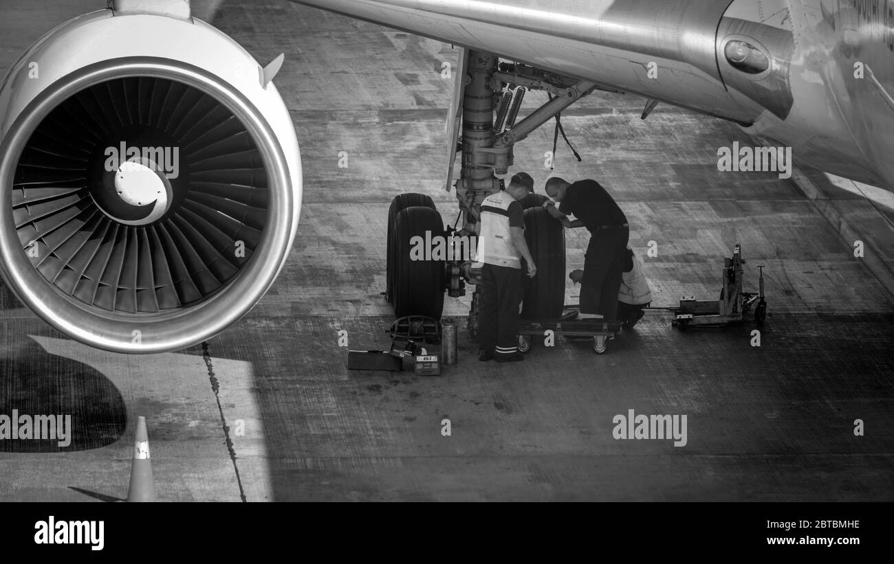 Black and white image of maintenance ground crew checking and repairing
